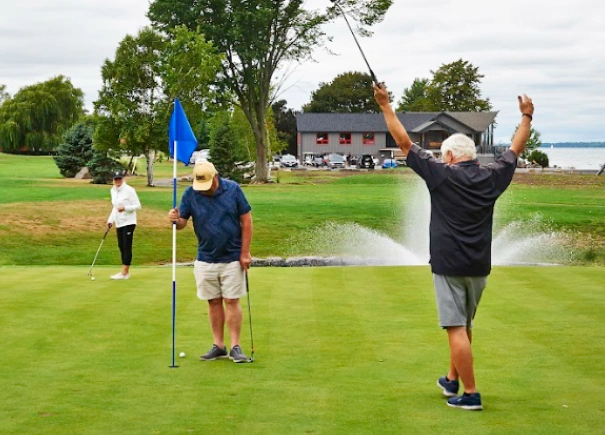 Golfers playing on Limestone Bay's private waterfront golf course